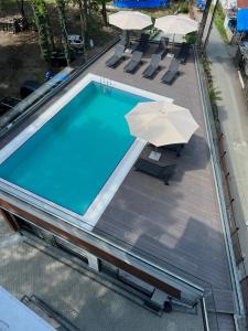 an overhead view of a swimming pool with umbrellas at Ritsa Resort in Ureki