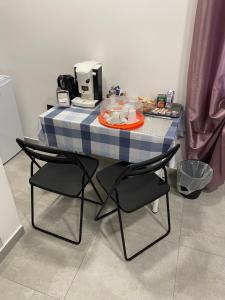 a blue and white table with chairs and a coffee maker at Tufaro B&B in Macerata Campania