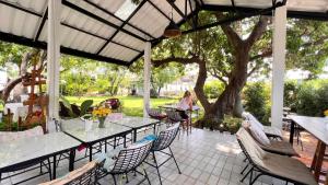 a woman sitting at a table on a patio at UDEE Cozy Hotel in Chiang Mai