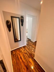 a hallway with a mirror and wooden floors at Alsdorf 3 in Alsdorf