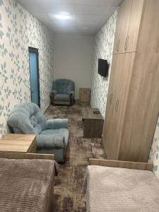 a room with two beds and a couch and a tv at BEST ROOM 4 in Yerevan