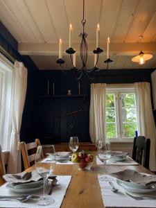 una sala da pranzo con tavolo e bicchieri da vino di « SoFly Cottage », le charme pur a Noresund