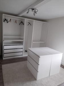 a room with white cabinets and a white desk at Appartement 2 chambres à Theux in Theux