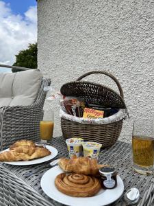 a table with two plates of food and a basket of food at Hawkshead Suites in Hawkshead