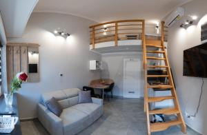 a living room with a loft bed and a couch at Tisza Apart in Tiszaújváros