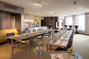 a dining room with long tables and chairs at Dorint Hotel am Heumarkt Köln in Cologne