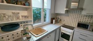 a kitchen with a sink and a window at Au fil de l'eau in Avignon