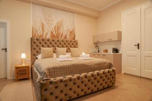 a bedroom with a large bed and a kitchen at Sting Old Town Ostrava in Ostrava