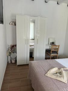 a bedroom with a bed and a desk in a room at Agrielia Studios Katigiorgis, Agios Georgios in Agios Georgios