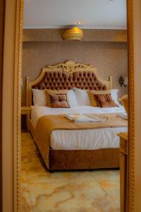 a bedroom with a large bed in a mirror at Luxury Apartments 'Rich' in Velingrad
