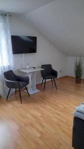 uma sala de estar com uma mesa e duas cadeiras em Stadt-Land-Fluss em Wickede (Ruhr)