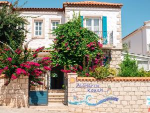 a building with flowers in front of it at AlaNarin Konak in Alacati