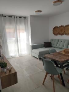 a living room with a couch and a table at SUDAMERICA38 in Roquetas de Mar