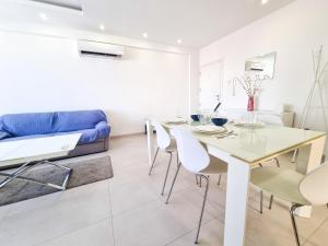 a living room with a table and chairs and a couch at Seaside Elegance Retreat in Larnaka +7 photos