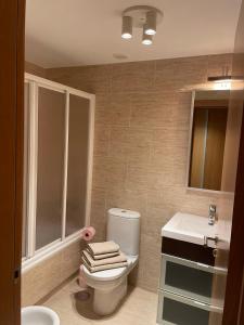 a bathroom with a toilet and a sink at Apartamento con vistas al mar B3 Urb Puerto Azul in Cedeira