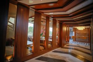 a hallway with wood paneling and a dining room at The Ekling Garh Hotel & Resort in Udaipur