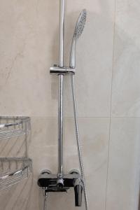 a shower with a shower head in a bathroom at LIV - View and the City Studio in Athens in Athens +6 photos