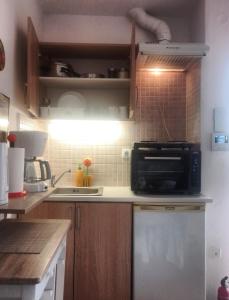 a kitchen with a microwave oven and a sink at Acropolis studio with breathtaking city view in Athens