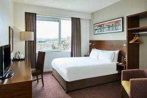 um quarto de hotel com uma cama e uma grande janela em Leonardo Hotel Bradford - formerly Jurys Inn em Bradford