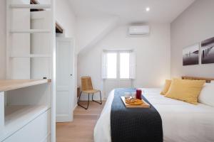 ein Schlafzimmer mit einem Bett und einem Tablett mit Essen drauf in der Unterkunft Ortigia Suite - Giudecca in Syrakus