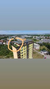 a building with an orange ring on top of it at Penthouse na 12 poschodí s terasou a výhľadom na celé mesto in Nitra