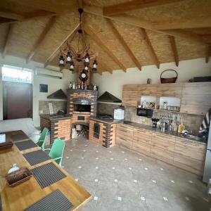 a large kitchen with a table and a fireplace at Villa in Bishkek