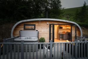 a small building with a sauna on a deck at Fern - Beacon View Pods in Knighton