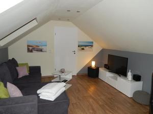 a living room with a couch and a flat screen tv at Grit´s Ferienwohnung in Ostseebad Karlshagen