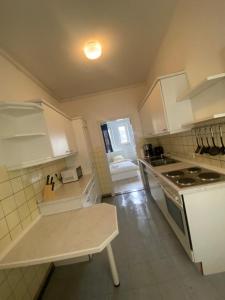 a kitchen with white cabinets and a stove at Monteurwohnung am Holstein-Center in Itzehoe