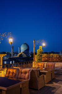 a couch sitting on a balcony at night at Gur Emir Palace in Samarkand