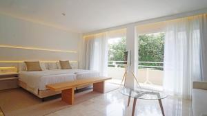 a bedroom with a bed and a large window at Canyamel Park Hotel & Spa - 4* Sup - Adults only (+16) in Canyamel