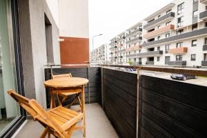 uma varanda com duas cadeiras e uma mesa num edifício em Cosmo Mountain Escape w. private parking em Brasov
