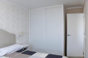 a bedroom with a large sliding closet door at Sunset 4C in Santa Pola