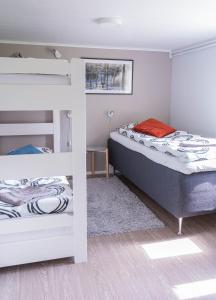 a bedroom with two bunk beds and a window at Haistila in Ranua