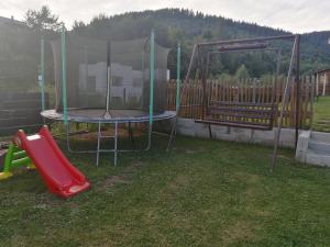 un parque infantil con cama elástica y tobogán en Domček u Vojta en Habovka