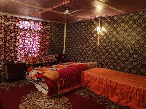 a bedroom with a bed and a table in it at Island in Srinagar