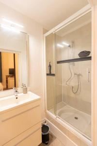 La salle de bains est pourvue d'une douche et d'un lavabo. dans l'établissement Avenue République La Ville aux pieds des Volcans Appartement au calme, à Clermont-Ferrand