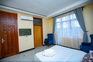 a bedroom with a bed and a chair and a window at Snow View Annex in Himo