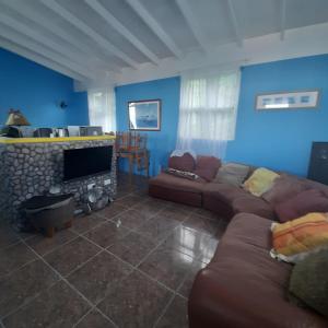 a living room with a couch and a fireplace at Canefield sea view apartment in Roger