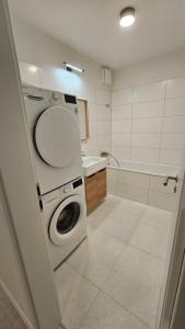 a bathroom with a washing machine and a sink at 2 room Apartment with terrace, new building, 2BK in Bratislava +9 photos
