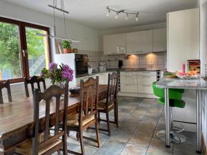 a kitchen with a wooden table and chairs in a kitchen at Behagliches Haus mit Kamin in Monschau