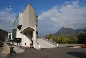 a building with a ramp in a parking lot at Living Kampill in Bolzano
