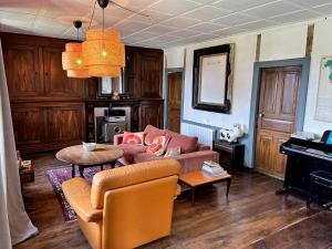 a living room with a couch and a table at Maison typique Auvergnate, piscine et four à pain in Saint-Christophe-les-Gorges