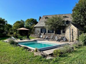 a swimming pool in front of a house at Maison typique Auvergnate, piscine et four à pain in Saint-Christophe-les-Gorges