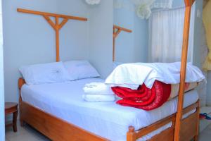 Tempat tidur dalam kamar di Perfect Guest House Kyotera
