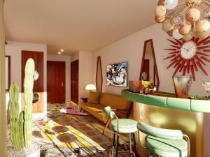 un soggiorno con divano e orologio sul muro di Los Felices Ibiza - New Opening 2024 a Baia di Sant'Antoni