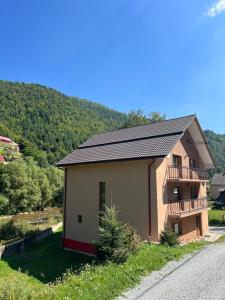 a small house with a balcony on the side of a road at Cabana Mario in Albac