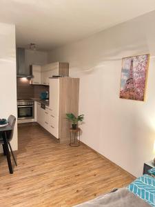 a living room with a kitchen and a table at Ferienwohnung Marion Klagenfurt Wörthersee Viktring in Klagenfurt