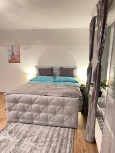 a bedroom with a large bed with a canopy at Ferienwohnung Marion Klagenfurt Wörthersee Viktring in Klagenfurt