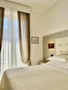 a bedroom with a bed and a large window at Albergo Degli Amici in Monterosso al Mare